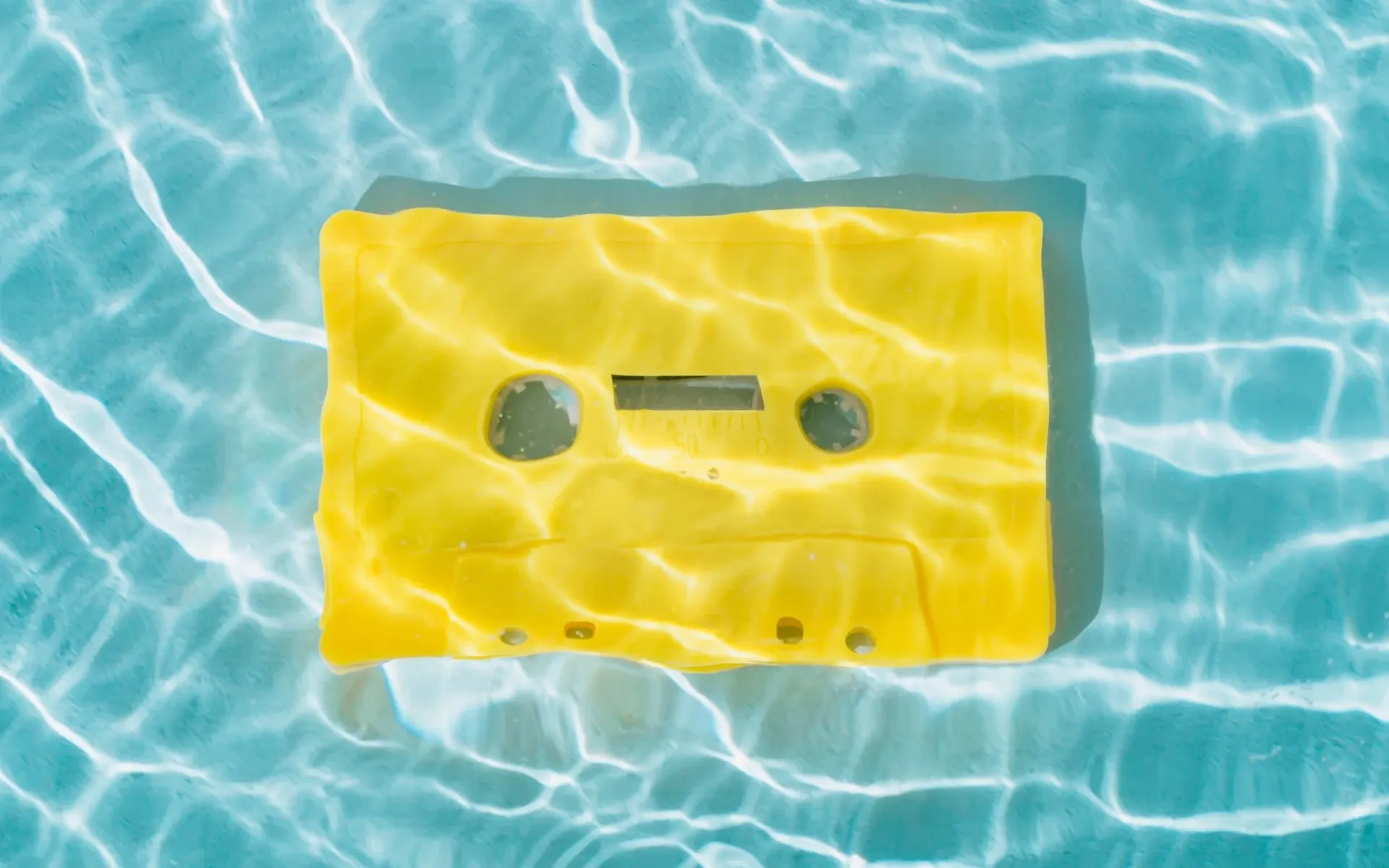 Yellow cassette tape under water