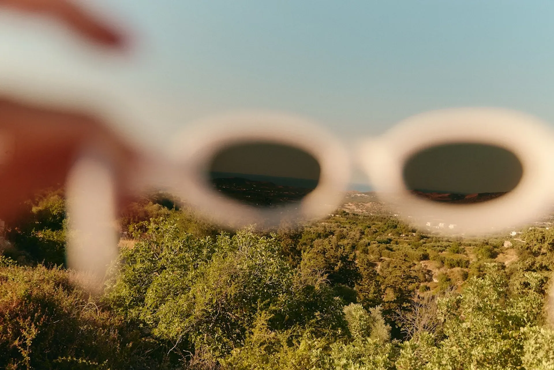A pair of sunglasses overlooking a hill
