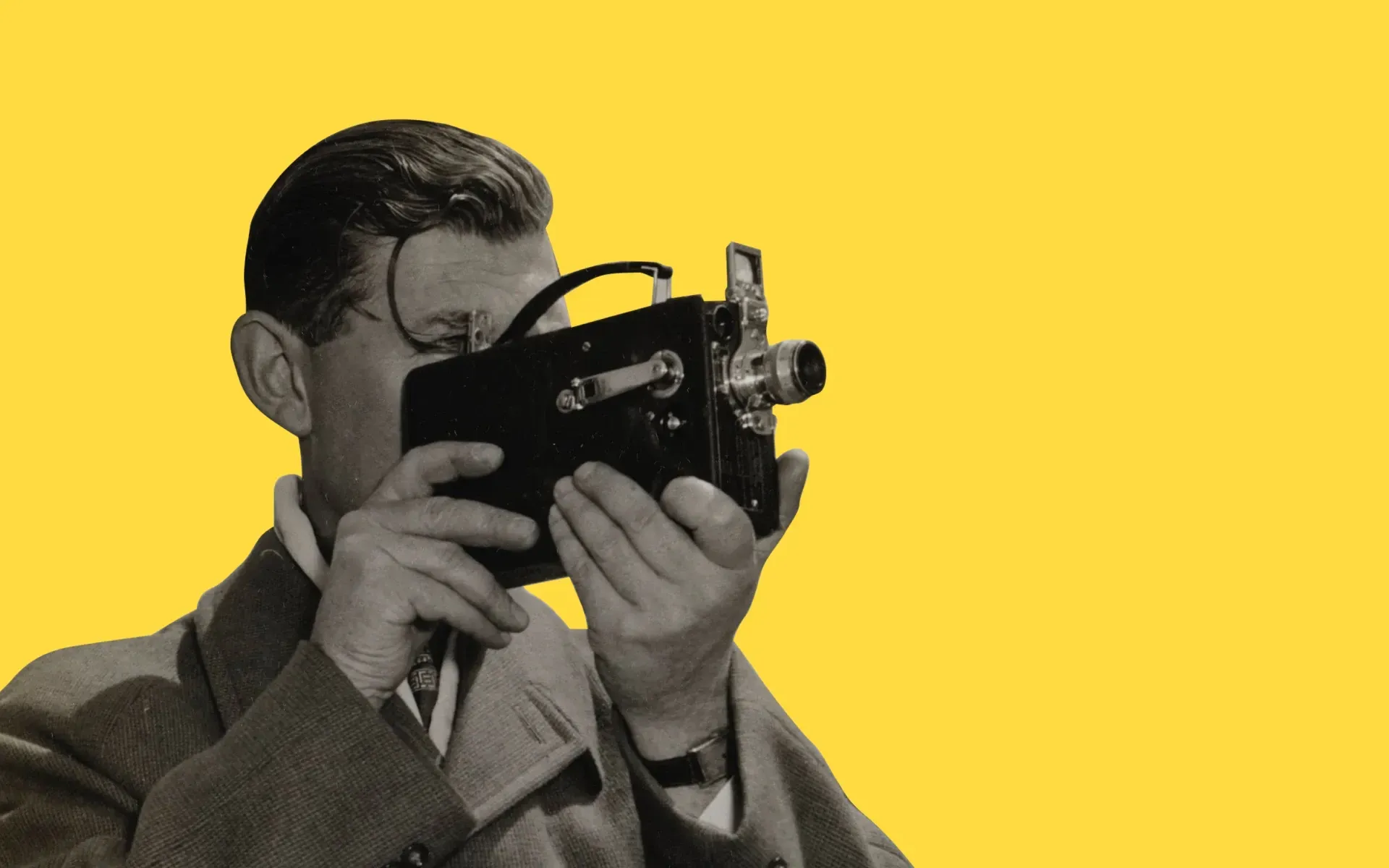 A man filming with an old-fashioned camera