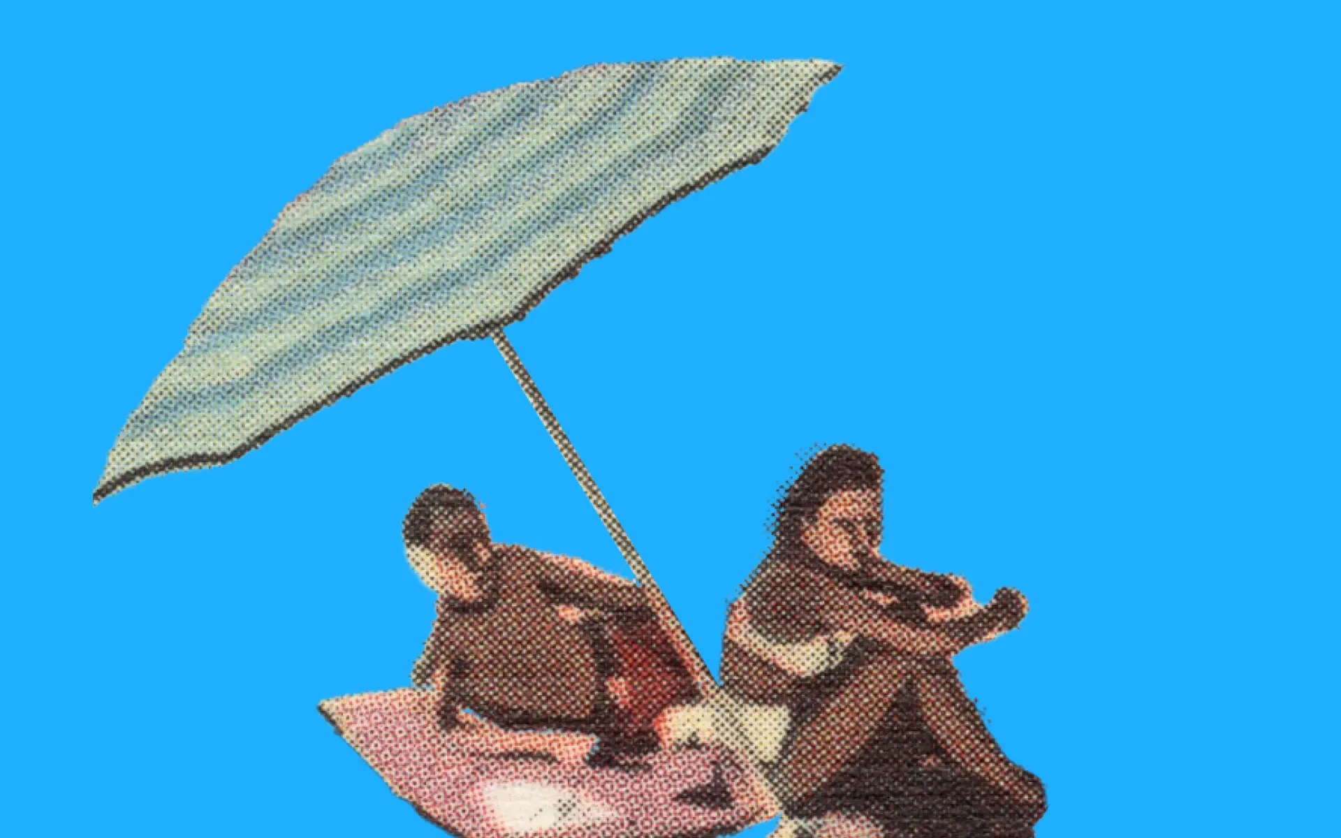 Two people sitting on the beach