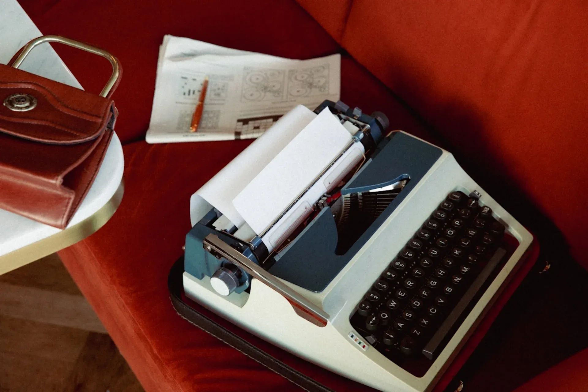 A typewriter on a red couch